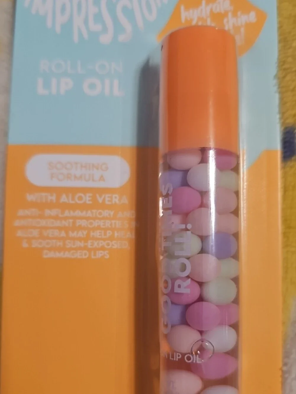 Impressions Roll-On Lip Oil in Orange Cap with Pastel Beads